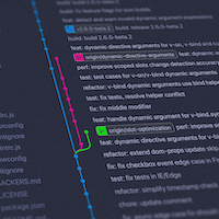 Computers with a person infront who has their hands on mouse and keyboard